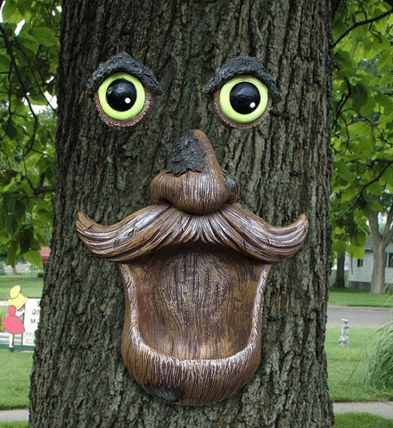 ALLADINBOX Tree Face Birdfeeder eyes detail attracting birds in a whimsical garden focal point.