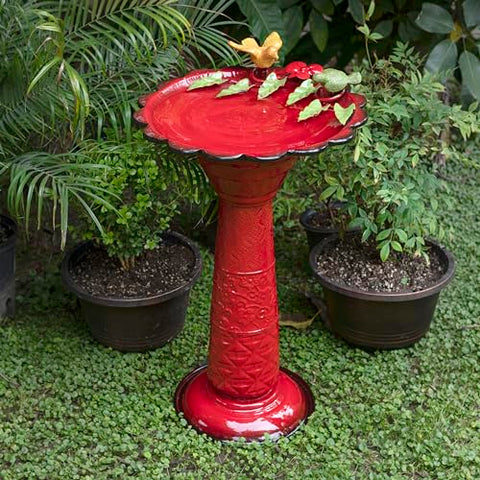Alpine birdbath with birds and leaves detail for charming yard decor.