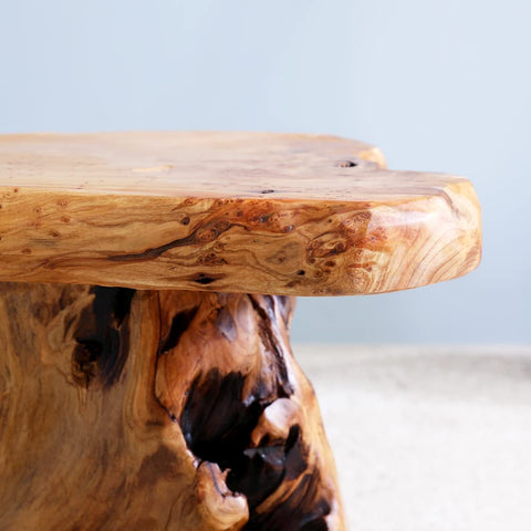 ALTERMATE cedar stump stool in a bedroom scene for compact seating.