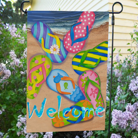 Anley 18x12.5 inch flag shown hanging in a sunny garden.