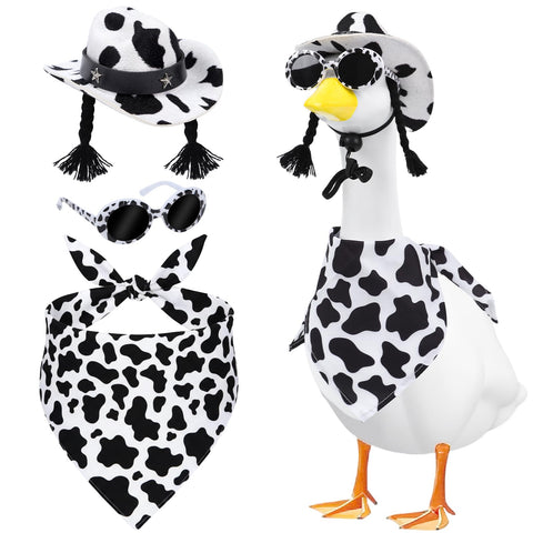 Aposwow cow-print hat on a goose statue adds playful outdoor charm.