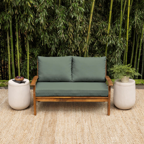Arden earthFIBER back pillow in sage provides outdoor support.