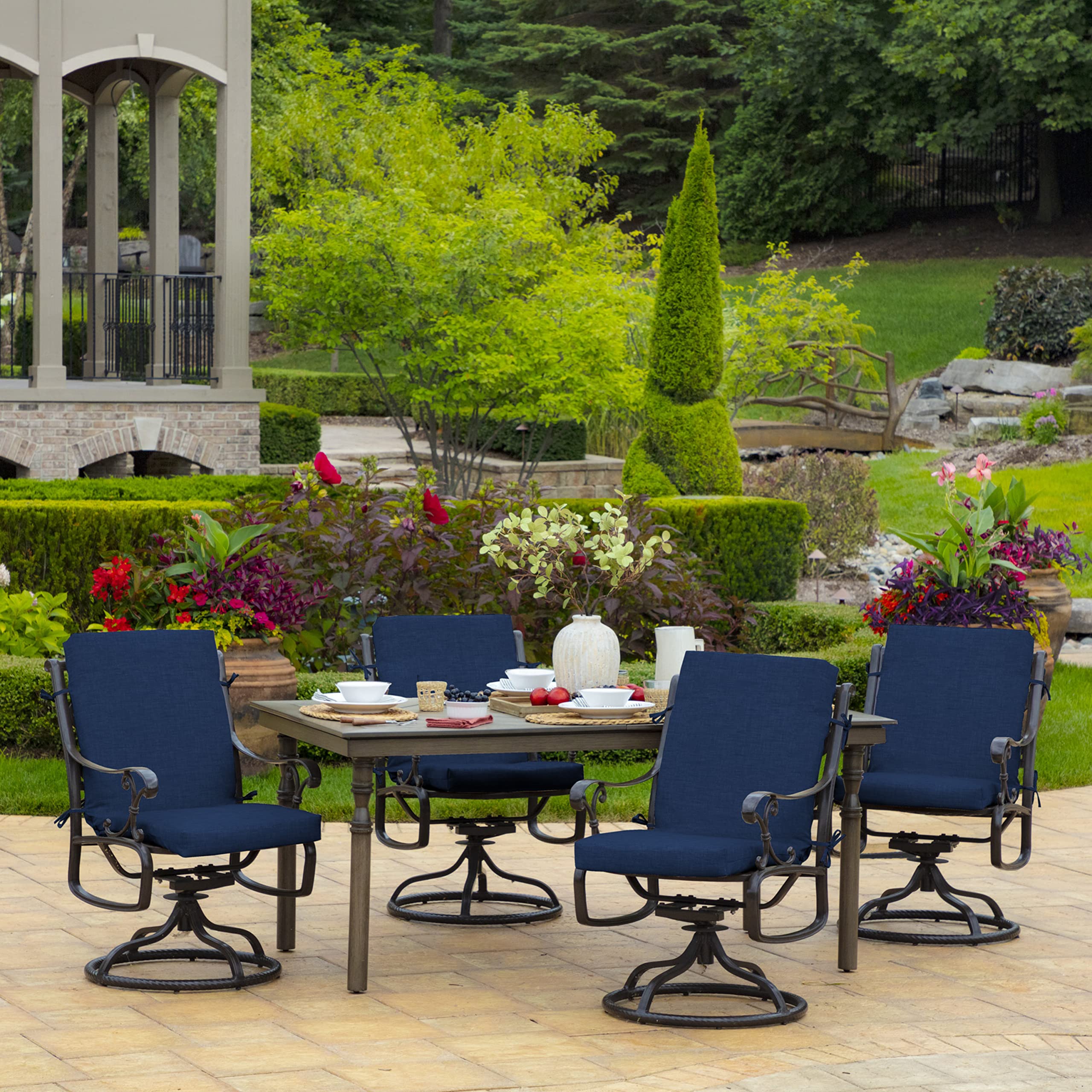 Outdoor garden scene with Arden Selections Leala cushion at dining table