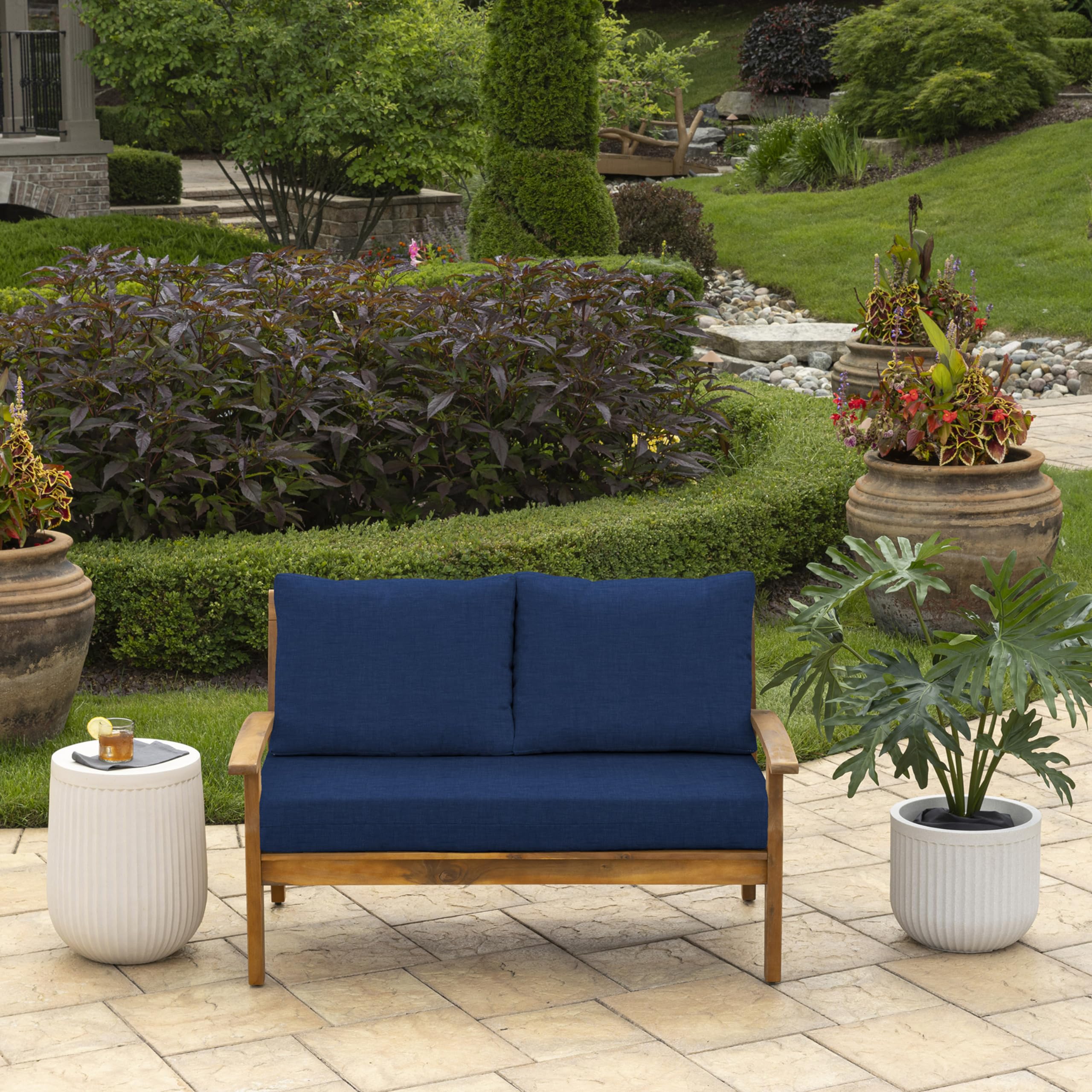 Arden Selections sapphire blue back pillow outdoor lounging side view