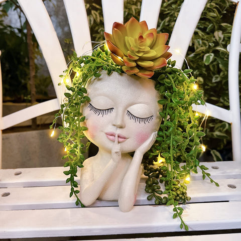ASDFG Head Planter with LED light string adding nighttime ambiance.
