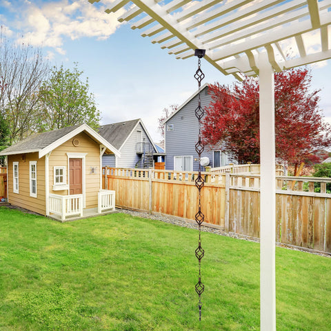 Garden decor scene featuring Aseneat rain chain along a gutter