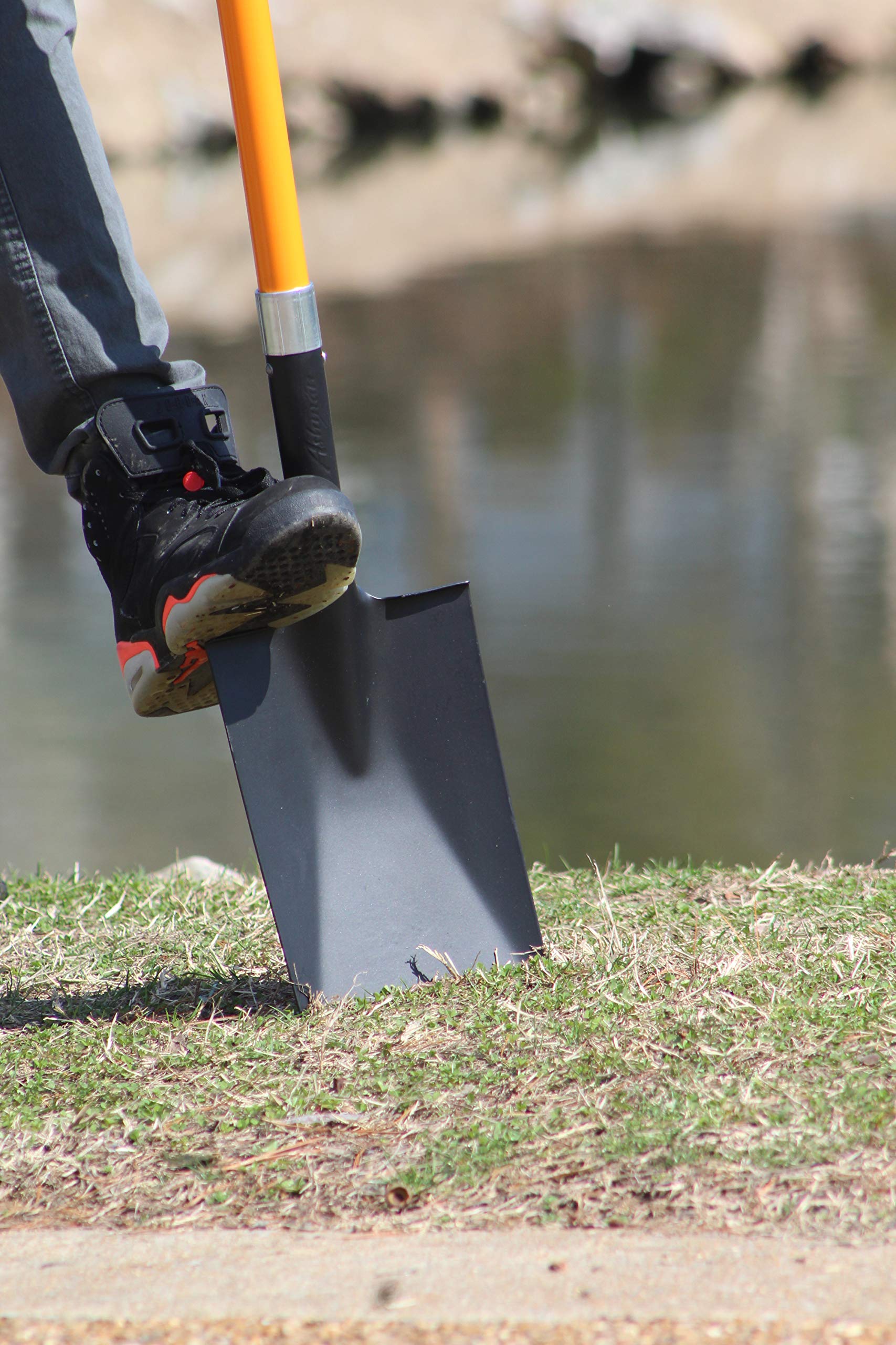 AshmanOnline spade shovel digging trench view demonstrates efficient trenching and soil displacement.