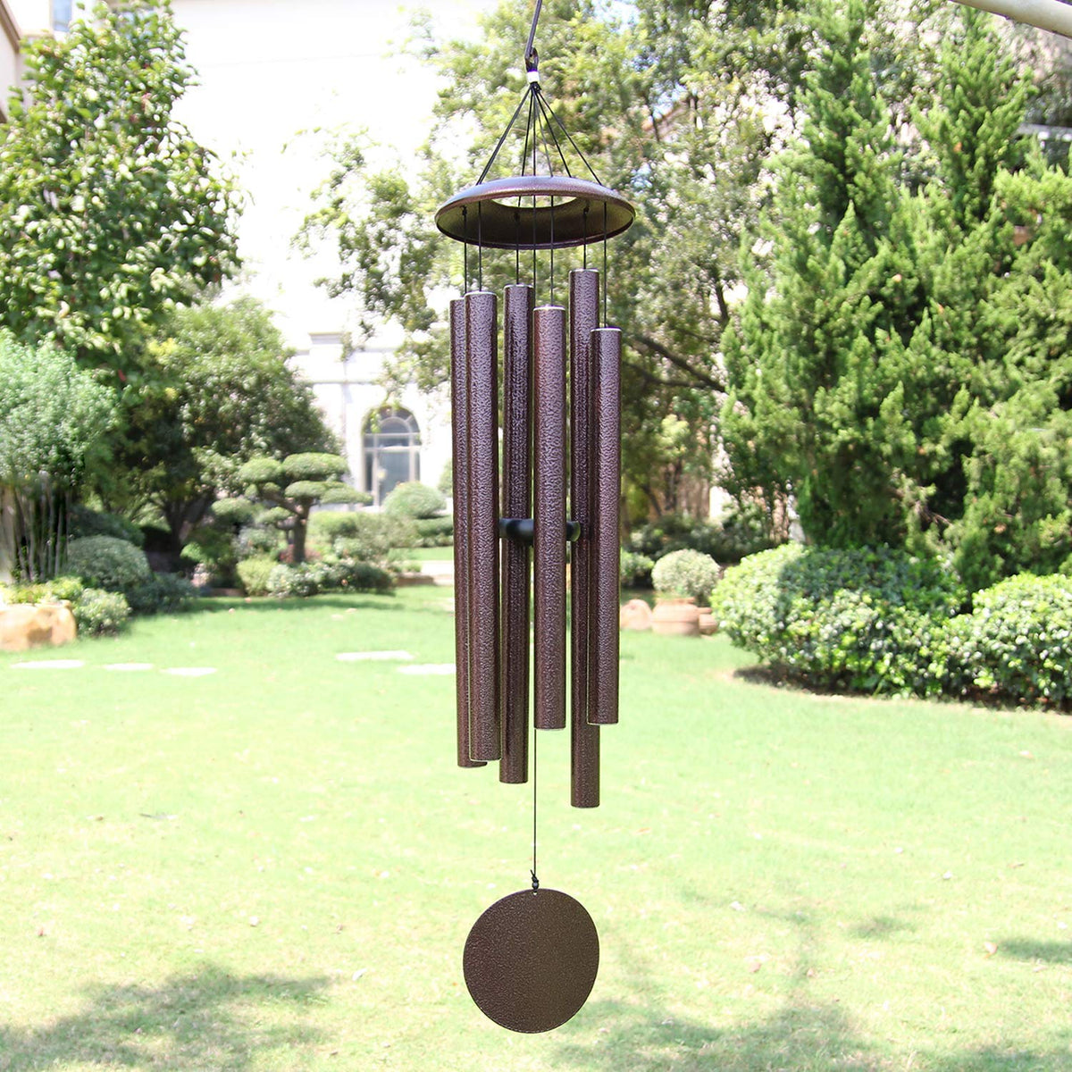ASTARIN 45-inch wind chimes hanging in bronze finish in a garden scene