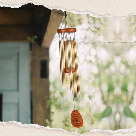 Aurahouse bride and groom motif wind chime enhances ceremony decor.