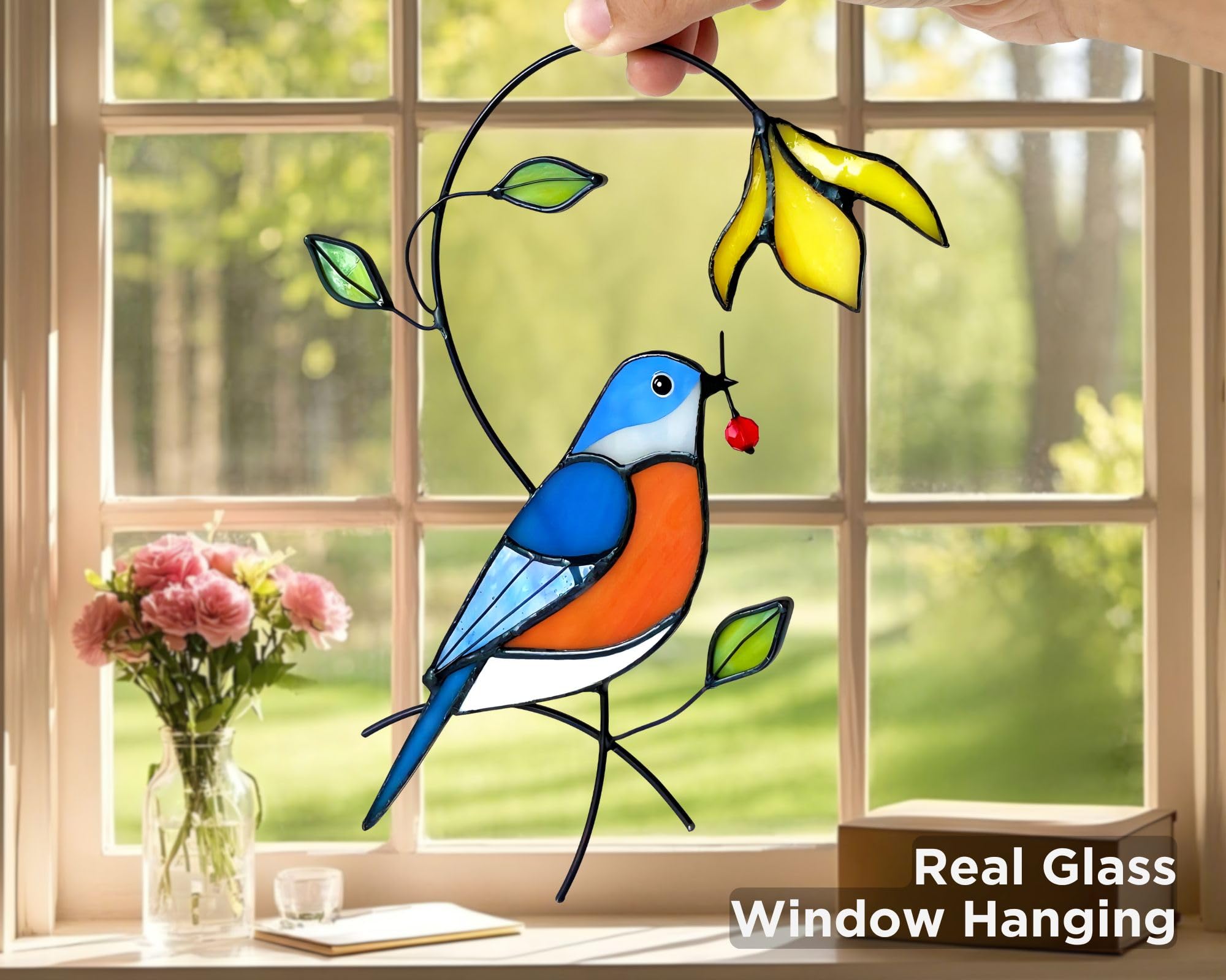 AuroAura bluebird suncatcher in window adds rainbow reflections to bright spaces.
