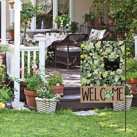 Eucalyptus and black cat welcome motif greets guests with seasonal charm.