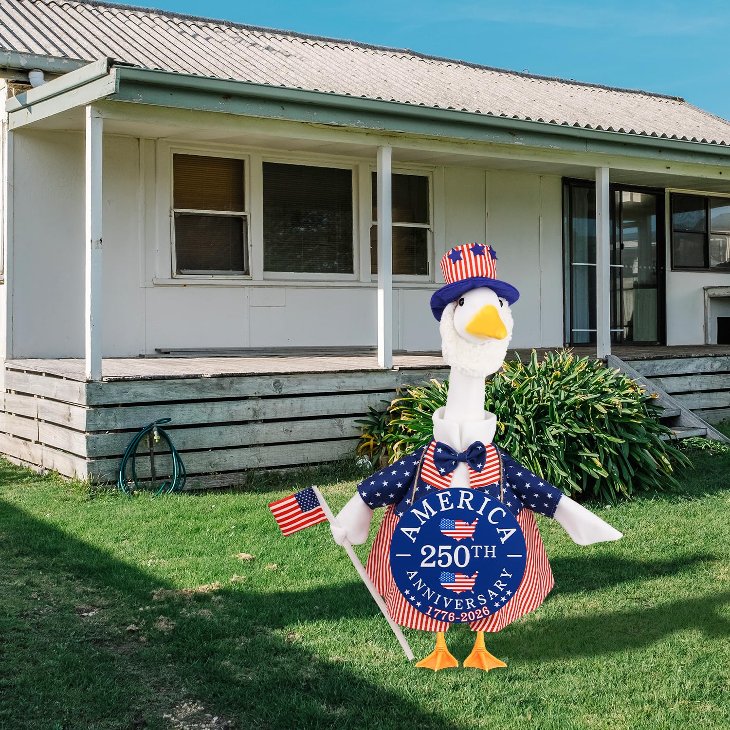 Aymolas US flag hat on a lawn goose adds patriotic flair.