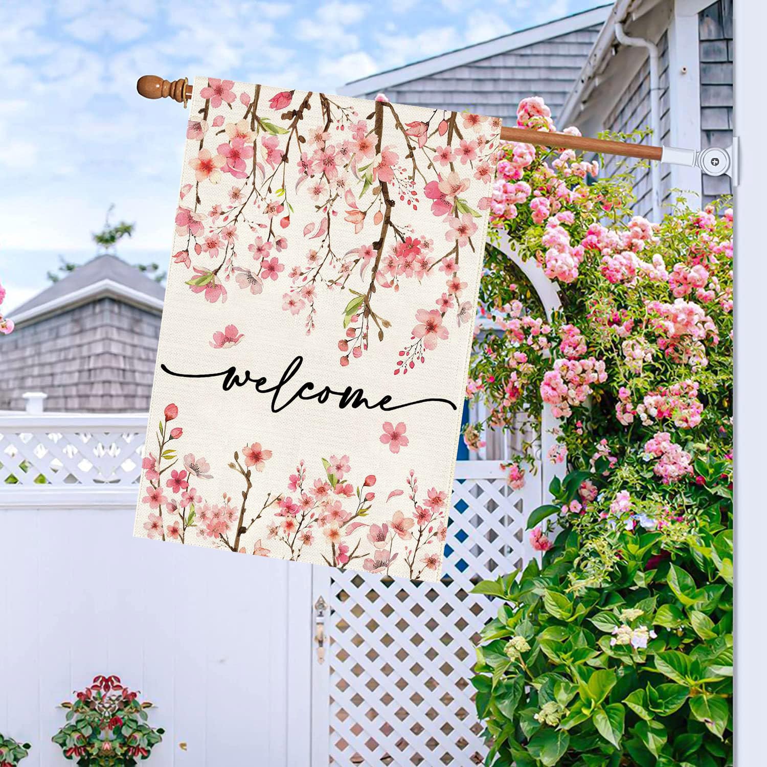 Baccessor cherry blossom yard flag features green leaves for springtime freshness.