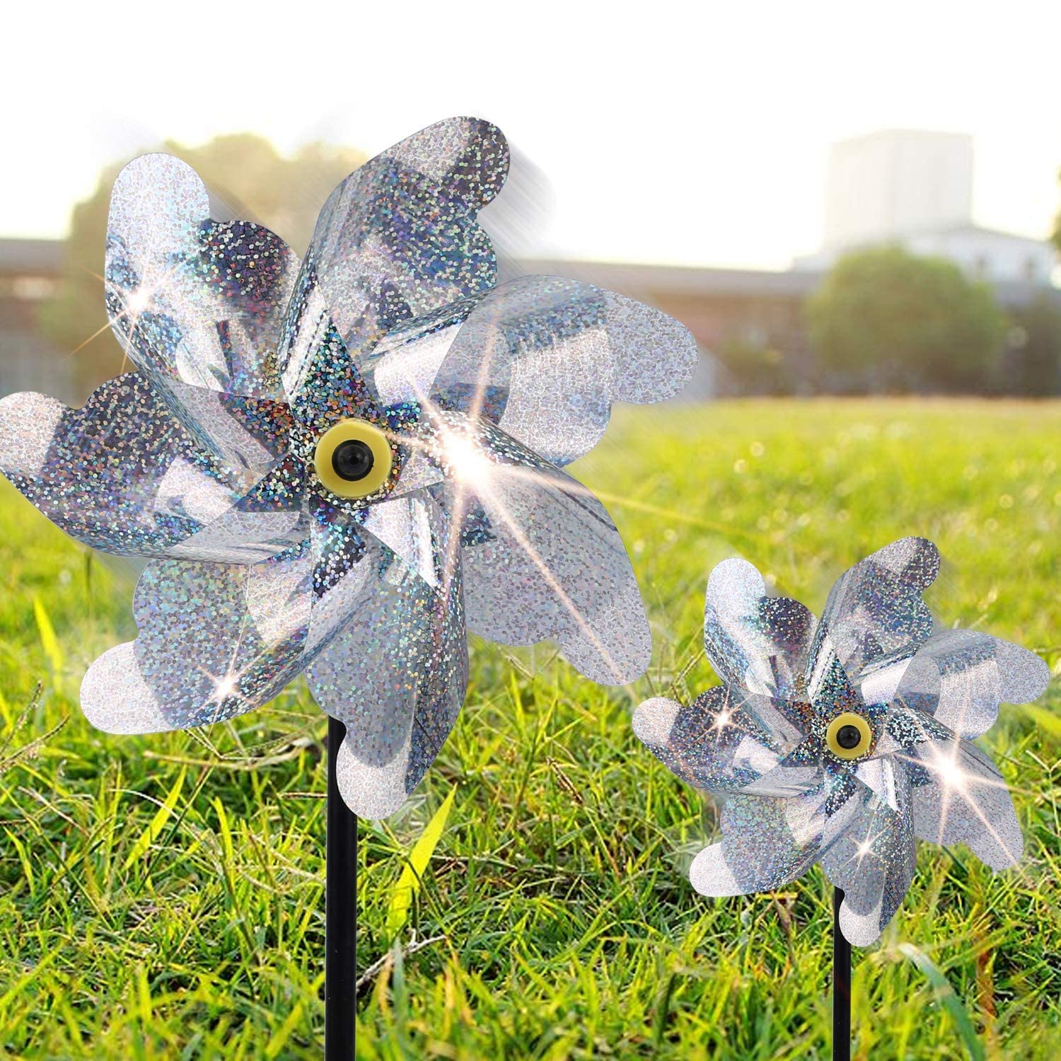 BATTIFE reflective pinwheels in the yard shimmer with motion and bright accents.