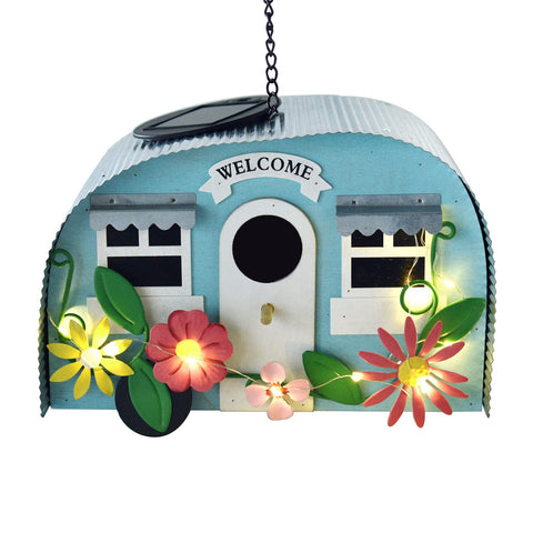 BAYN outdoor bird house in camper style with LED lights lighting the garden at night