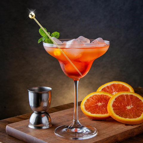 BBQStyle martini pick with olives elevates cocktail presentation.