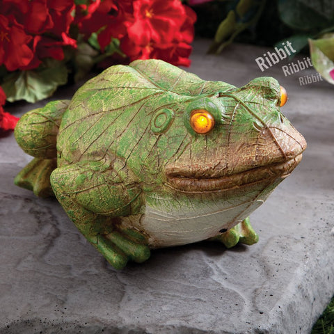 Bits and Pieces frog statue with glowing eyes at dusk for garden decor.