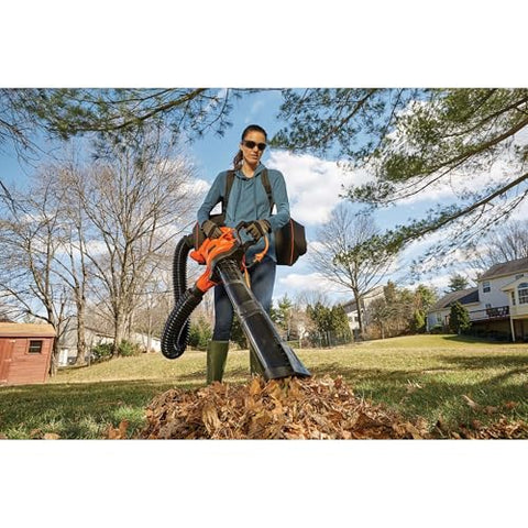 BLACK+DECKER BEBL7000 leaf vacuum action capturing leaves along a sidewalk.