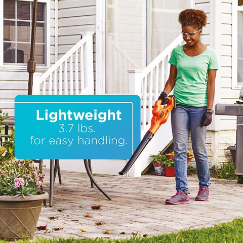 Lightweight BLACK+DECKER blower in hand during yard cleanup