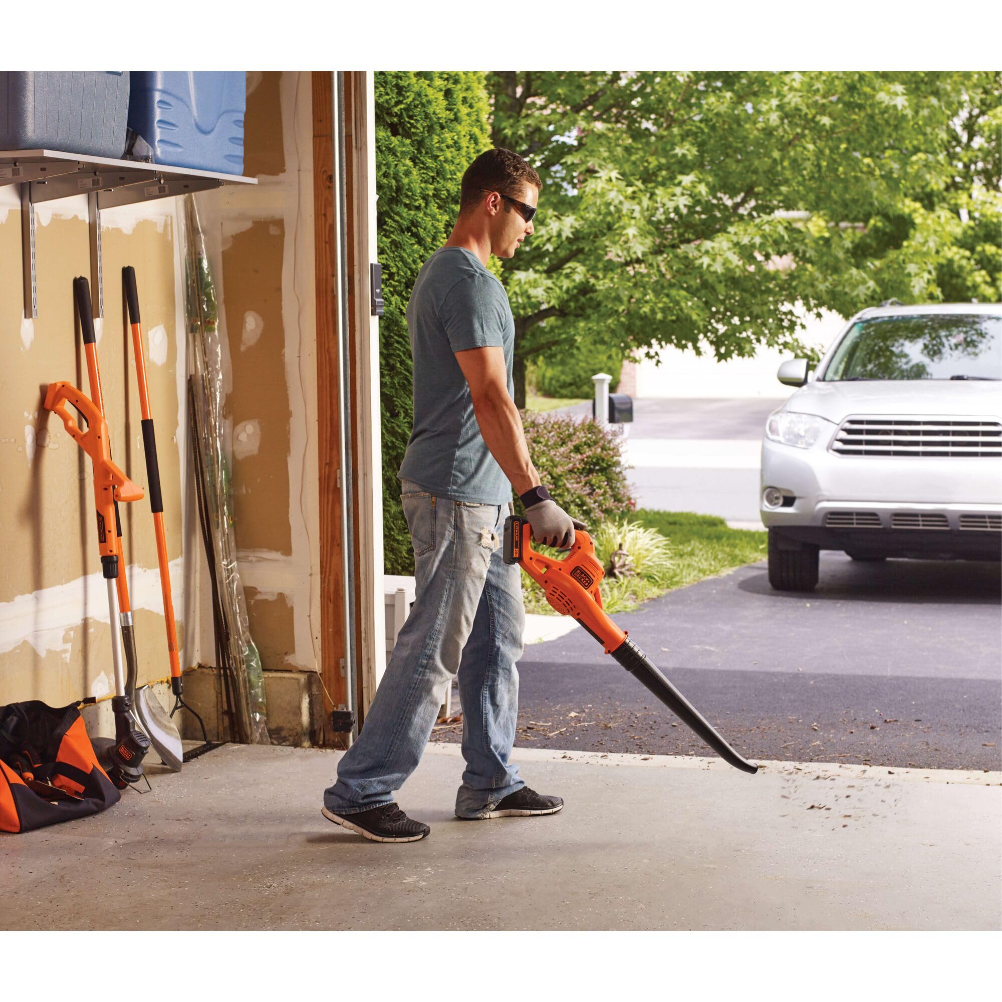 BLACK+DECKER blower tidying a cluttered garage space