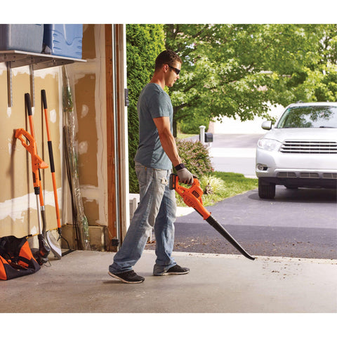 BLACK+DECKER blower tidying a cluttered garage space