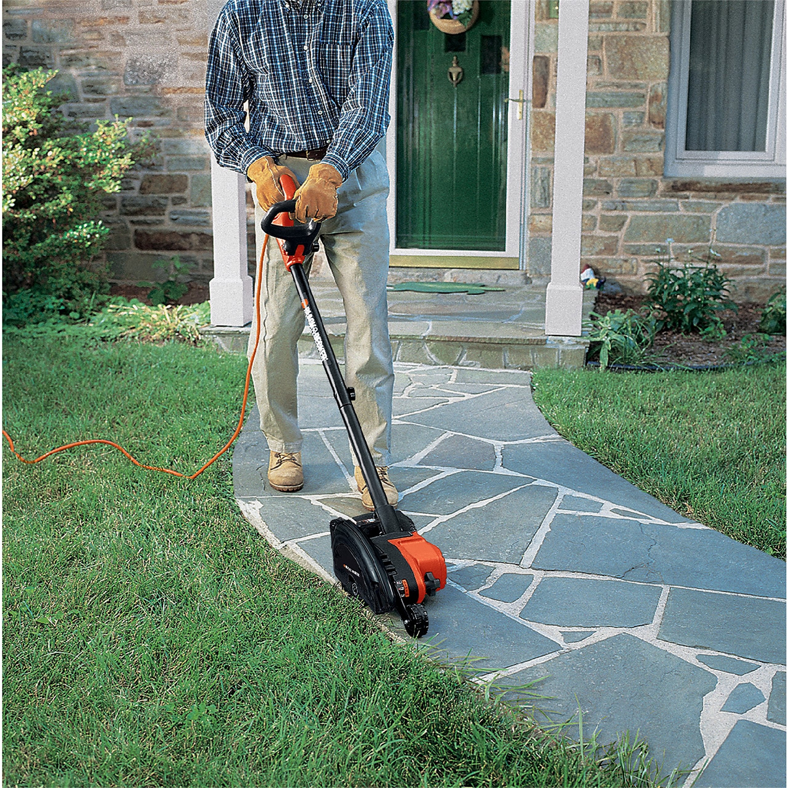Corded power tool capability shown digging a trench for irrigation.