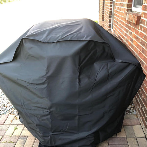 Wind-resistant hood design protecting grill in breezy conditions