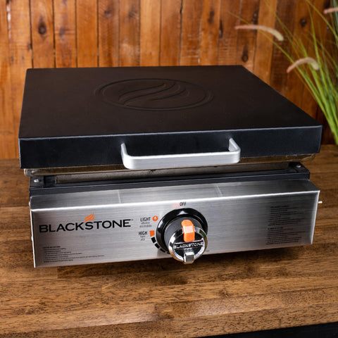 Blackstone 5701 hard cover side view with handle for easy placement and removal