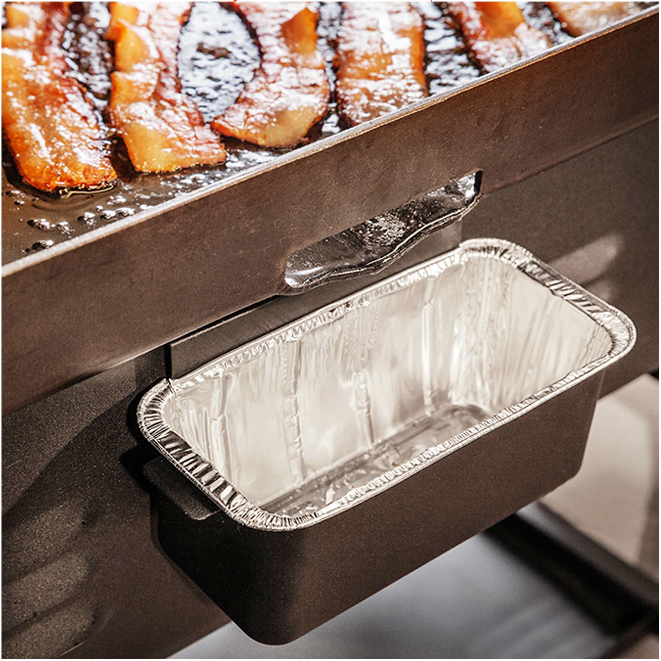 BLACKSTONE liner on heavy-duty foil tray catching grease during griddling.