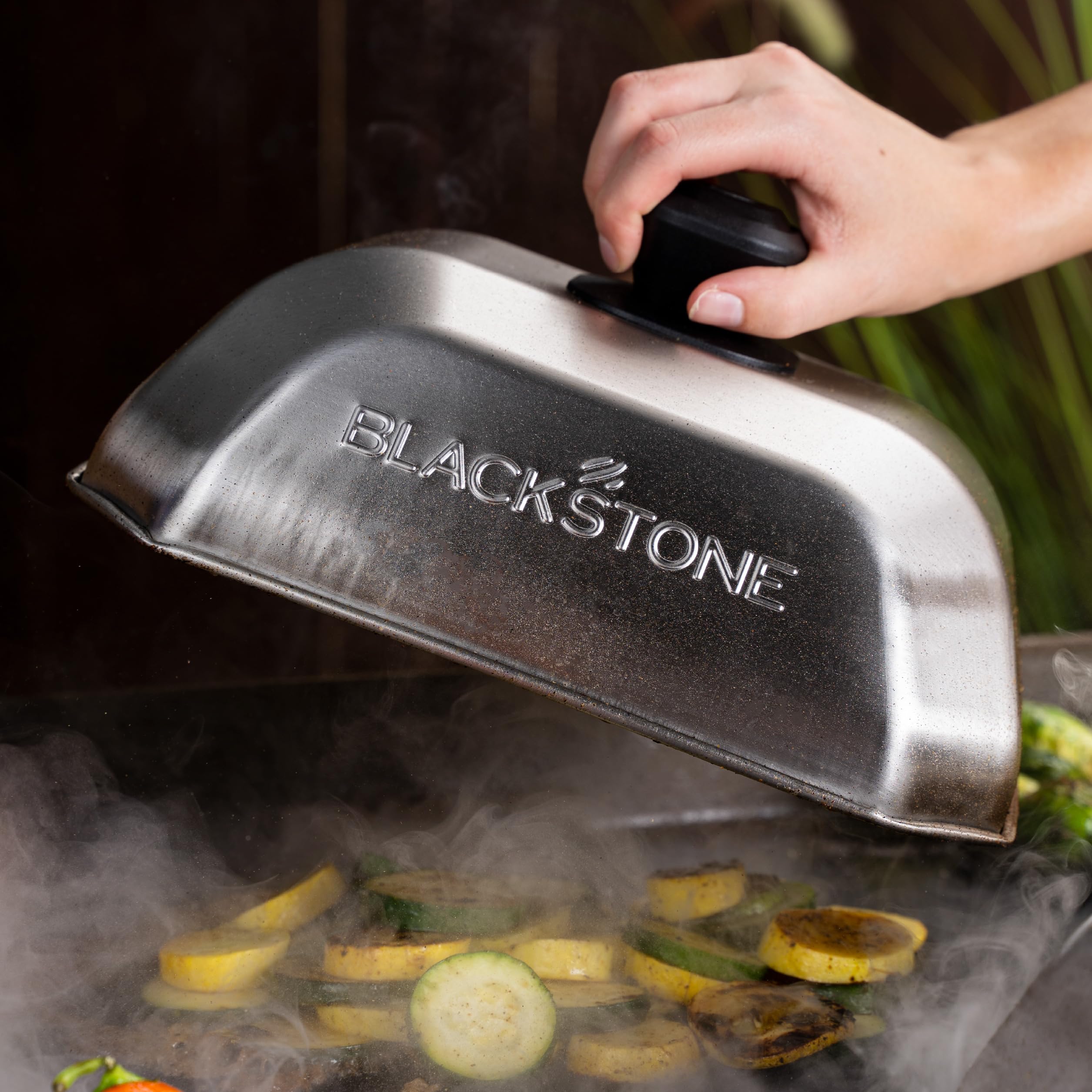 Blackstone basting dome steaming cover showcases grill versatility.