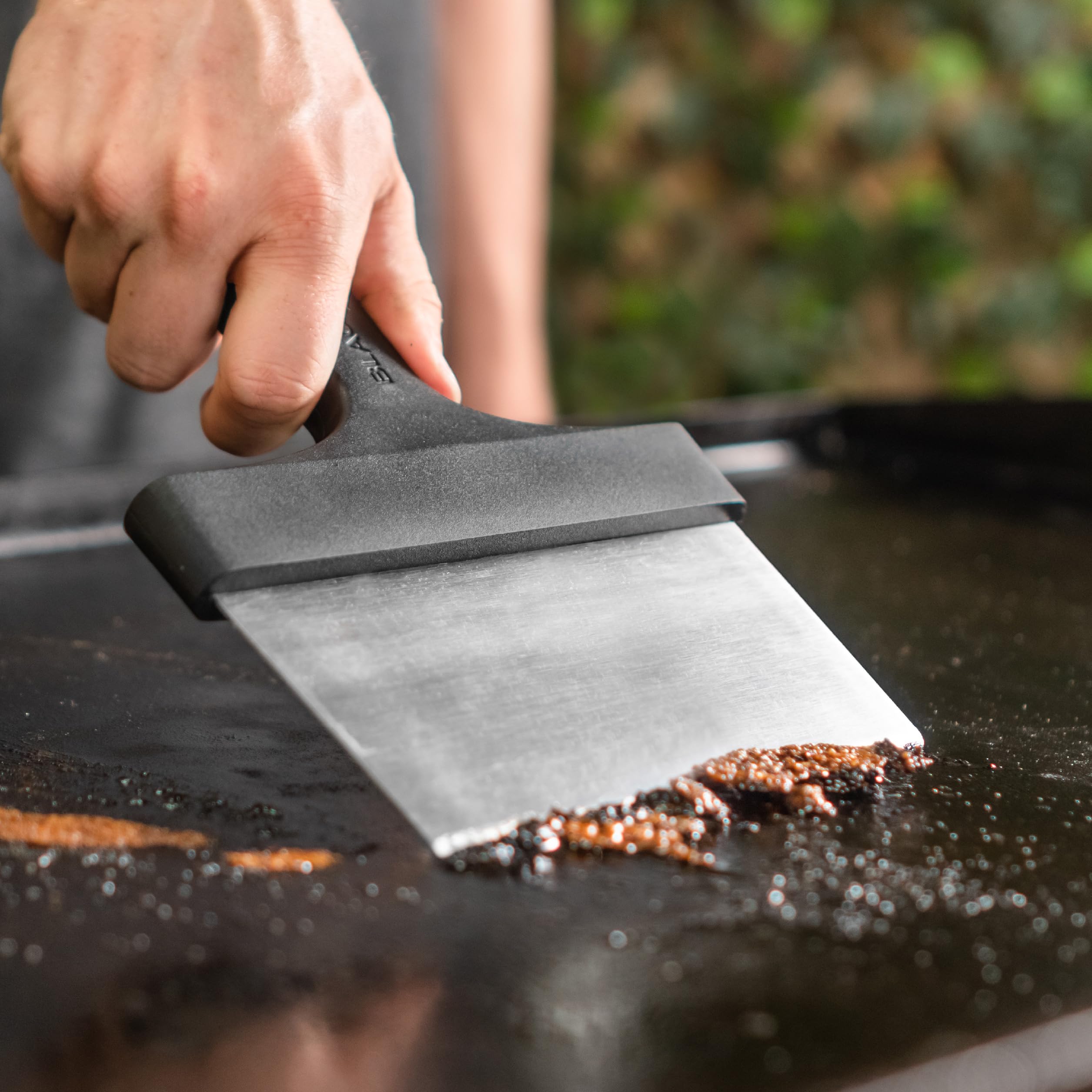 Blackstone griddle scraper showing beveled edges for tough residue