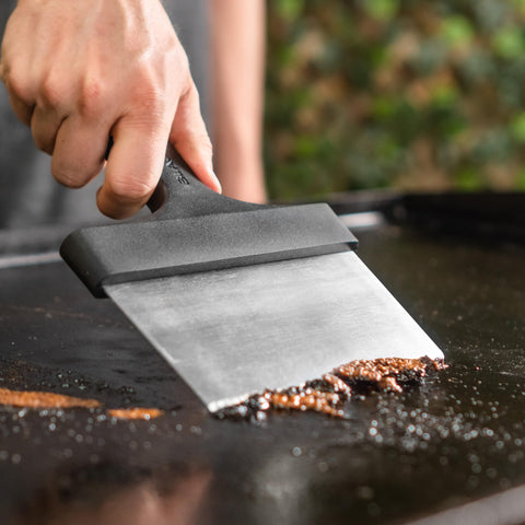 Blackstone griddle scraper showing beveled edges for tough residue