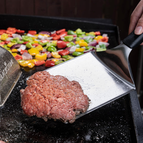 Close-up of Blackstone spatula blade with thin edge for delicate flips and burgers.