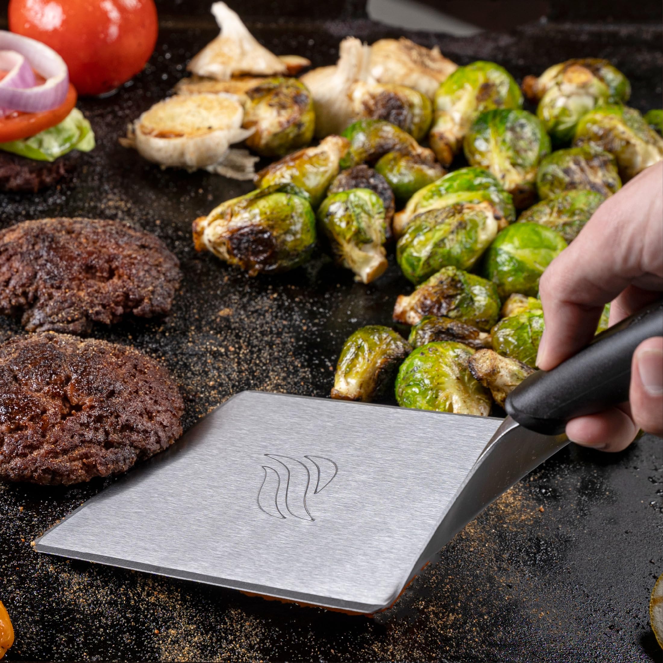 Blackstone spatula flipping pancakes on a hot griddle with precision.
