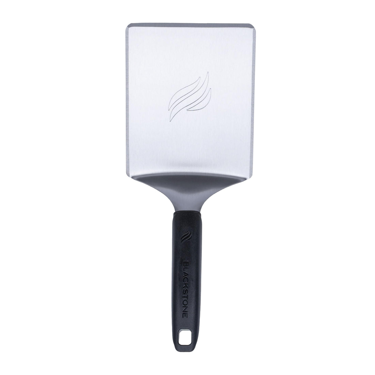 Blackstone hamburger spatula handle view showing ergonomic, cool-grip control on a hot griddle.