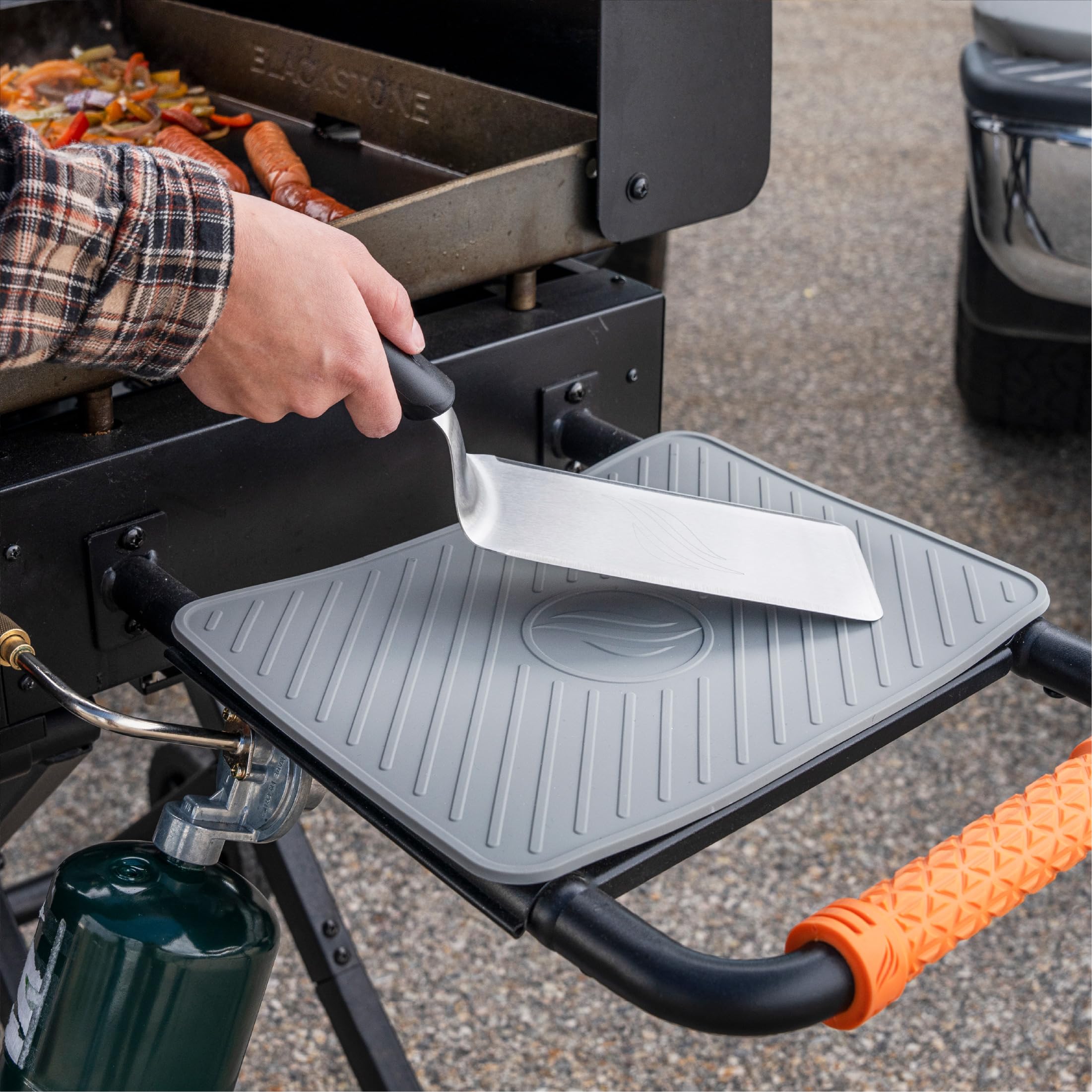 BLACKSTONE spatula mat showing grease drip catch protecting surrounding ingredients.