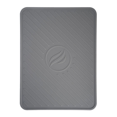 BLACKSTONE spatula mat on grill shelf catching drips and protecting surfaces.