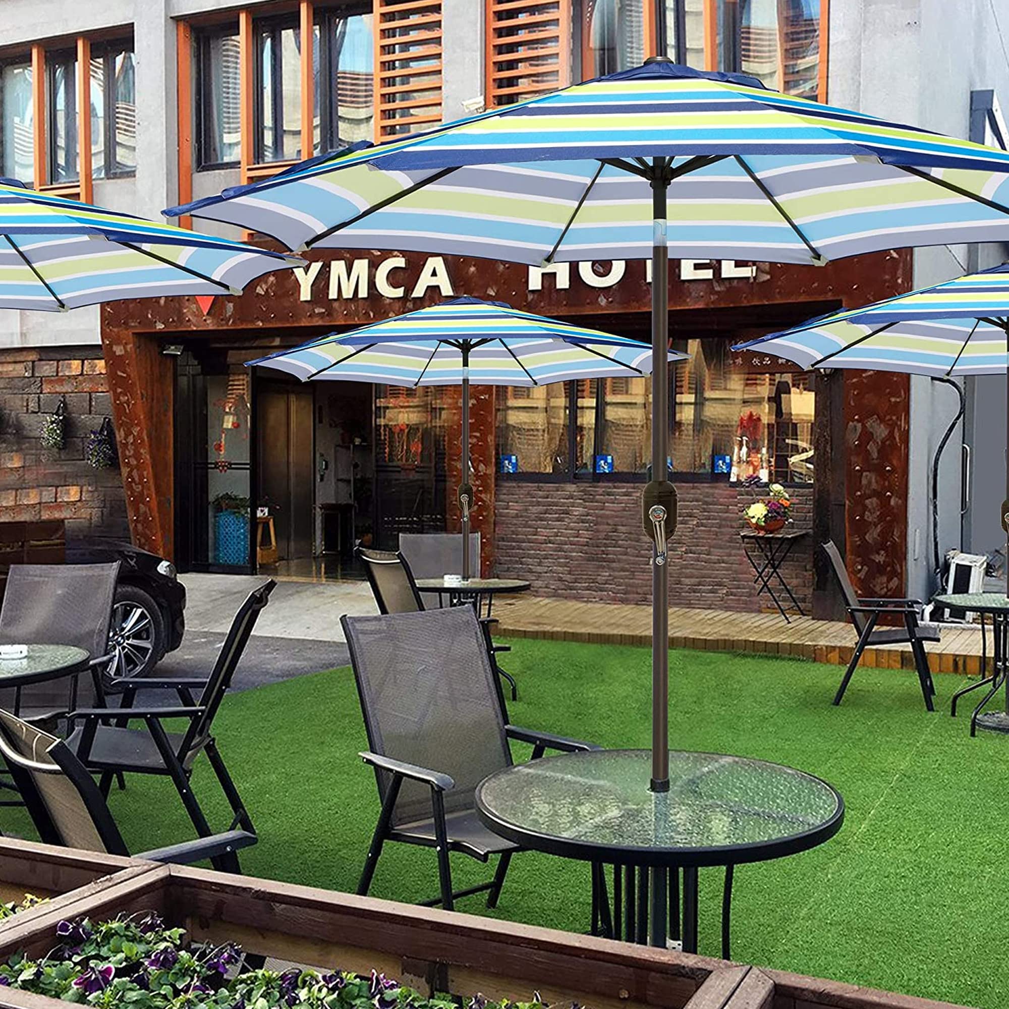 Blissun outdoor umbrella with blue-green stripes complements patios and pool areas.