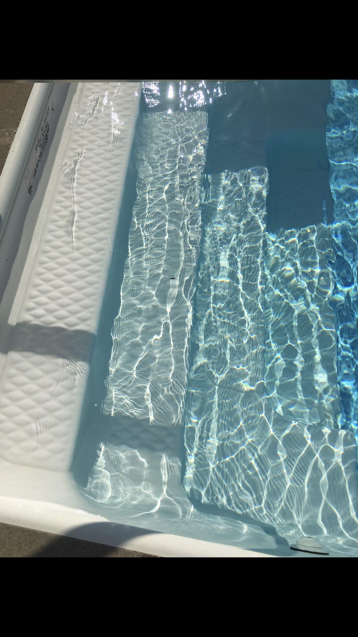 Rust and metal stains fading after using Vanish in pool.