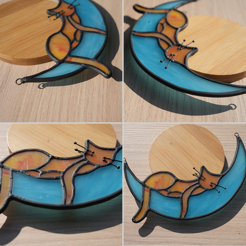 BOXCASA orange cat window decor adds warmth to a sunlit space.