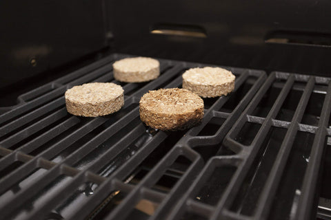 Bradley Smoker Mesquite Bisquettes in action on a grill.