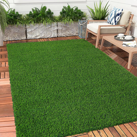 Bsmathom artificial grass rug with drainage holes for fast drying after rain.