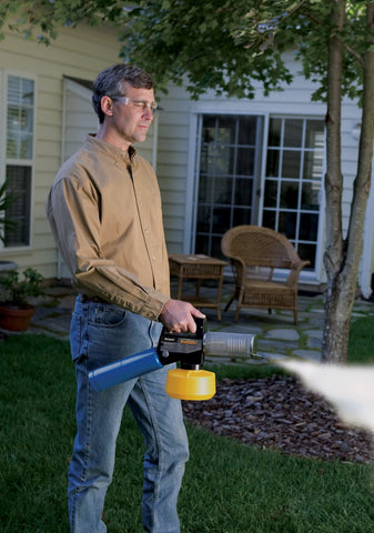 Outdoor scene showing fogging action before a backyard barbecue.