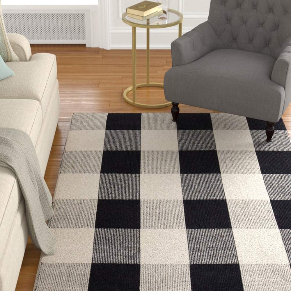 CAINANEL buffalo plaid rug layered with hello doormat on porch enhances welcome.