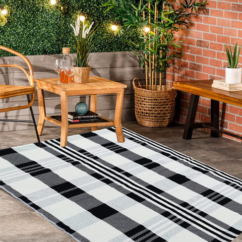 Close-up texture of CAINANEL buffalo plaid outdoor rug showing cotton weave