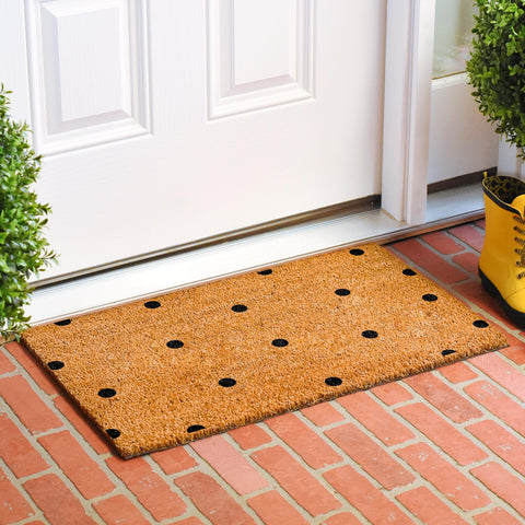 Calloway Mills black polka-dots mat features vinyl backing to prevent movement.