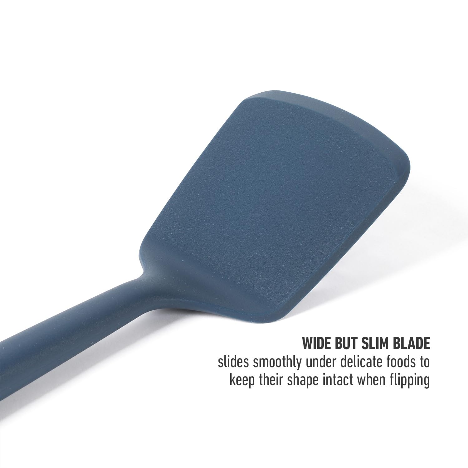 Calphalon Edge silicone turner in navy enables easy serving of pancakes and fish.