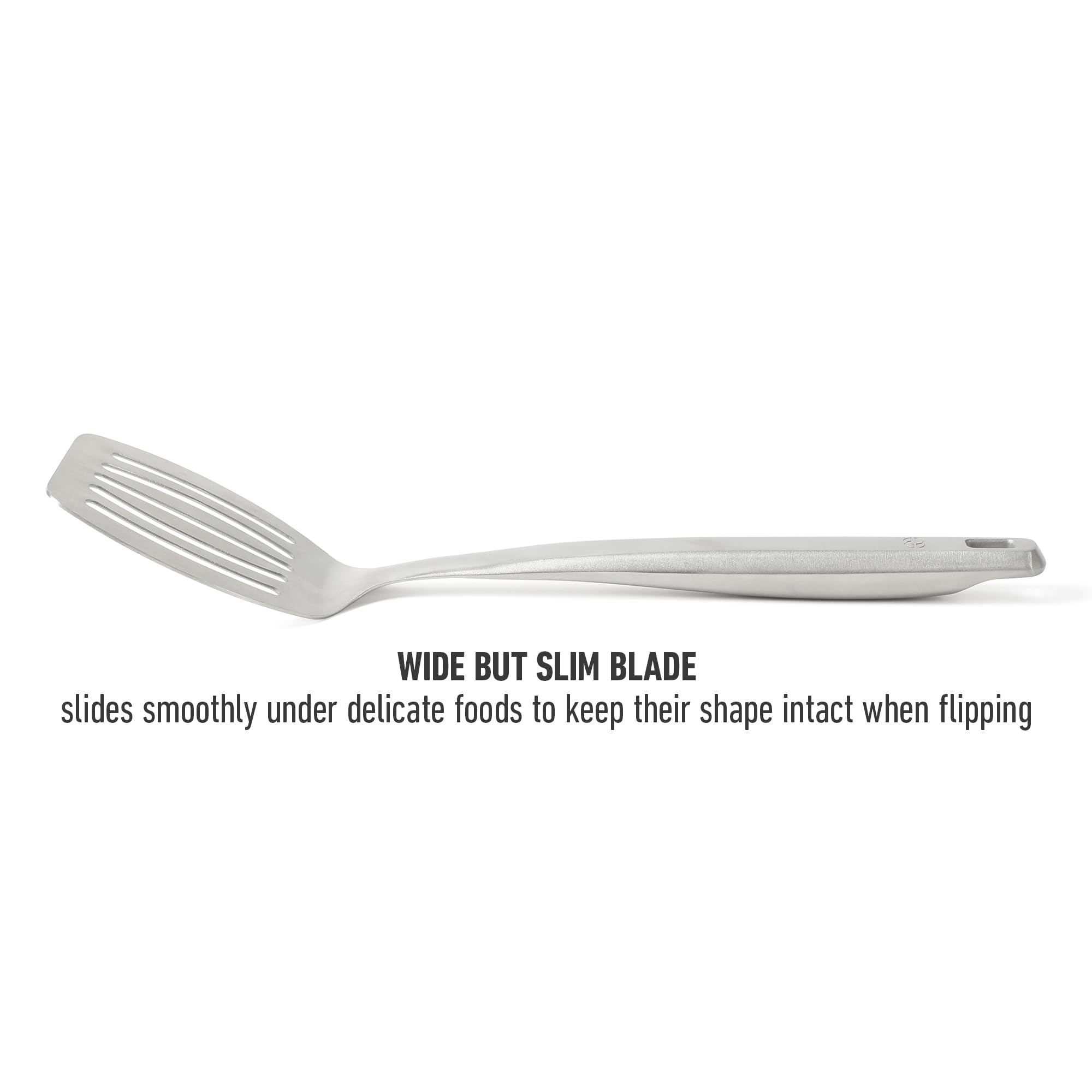 Calphalon Prime slotted turner in pan for efficient lifting.