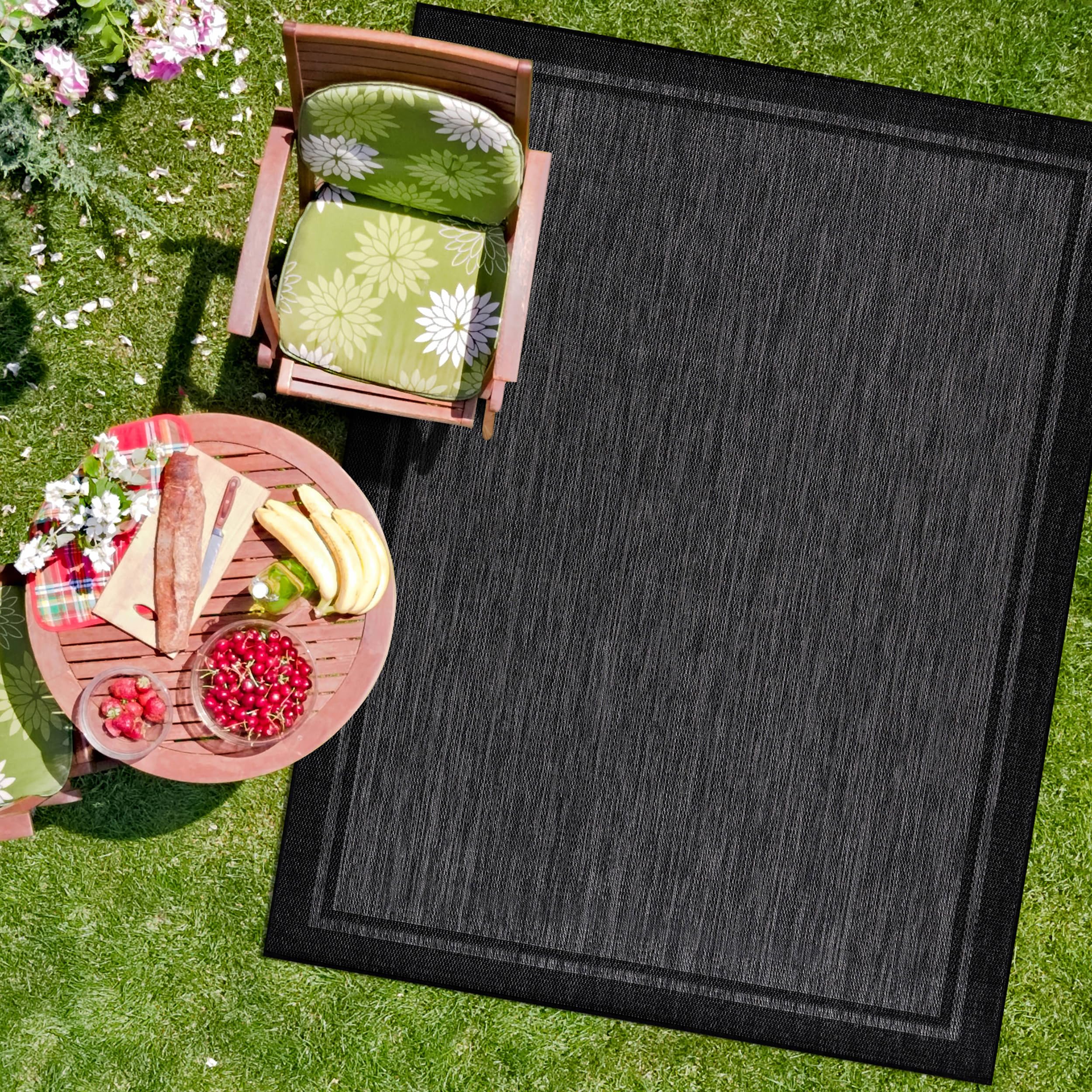 CAMILSON indoor outdoor rug bordered in black for versatile spaces