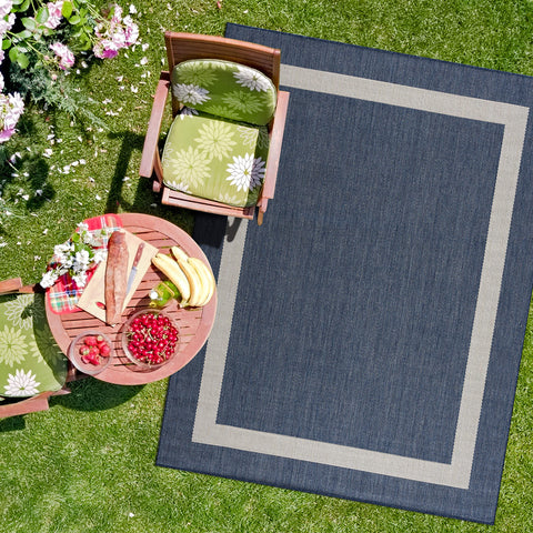 CAMILSON easy-clean rug shown being washed with hose outdoors.